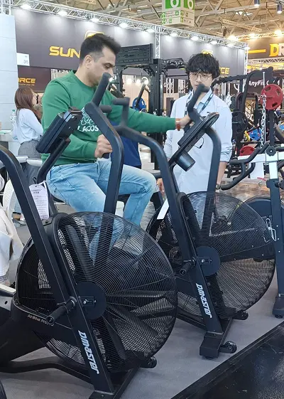 Visitors trying VEKTOR fan bike at FIBO 2025