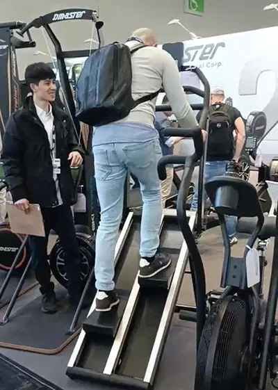 Visitors trying stair training equipment at FIBO 2025